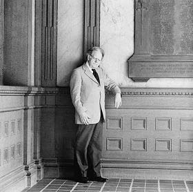 A man in a suit, Northrop Frye, posing for a photograph.