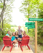 A family sit on the Red Chairs at Major Kollock Creek.