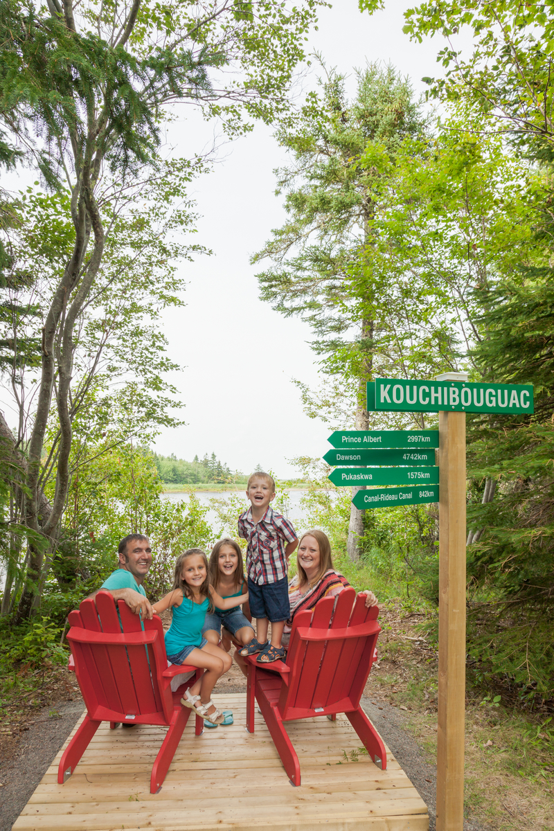 A family sit on the Red Chairs at Major Kollock Creek.