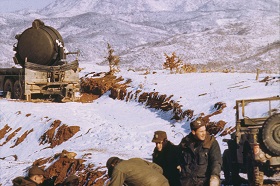 Soldiers on a hill in a Korean landscape