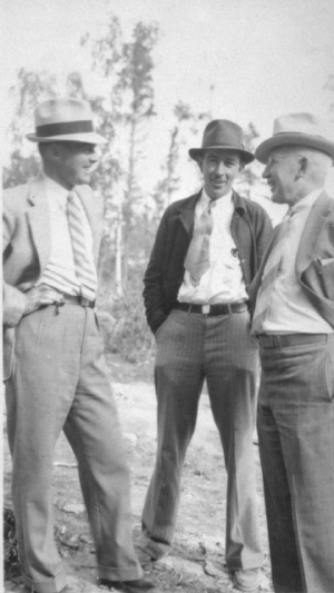 Historical image of three man standing and laughing
