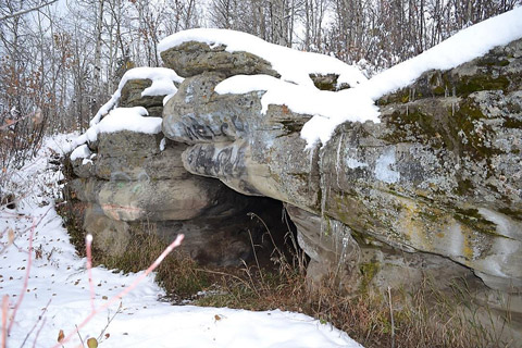 The Tse’K’wa cave entrance surrounded by snow.