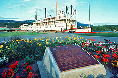 Photo of a commemorative plaque in front of a boat