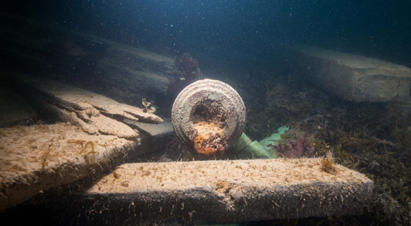 The cannon’s muzzle surrounded by large pieces of debris.