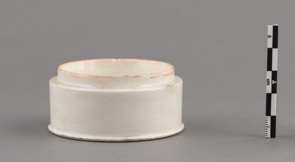 A small round white ceramic pot.