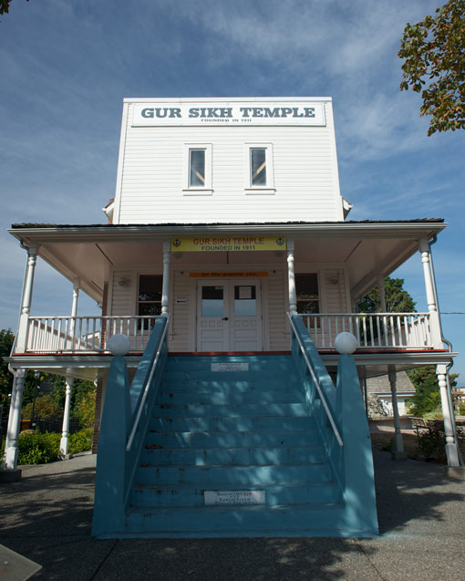 Outside view of Abbotsford Sikh Temple with its white façade and blue staircase