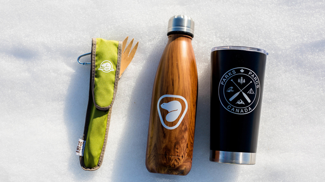 Parks Canada reusable merchandise products laid out in the snow