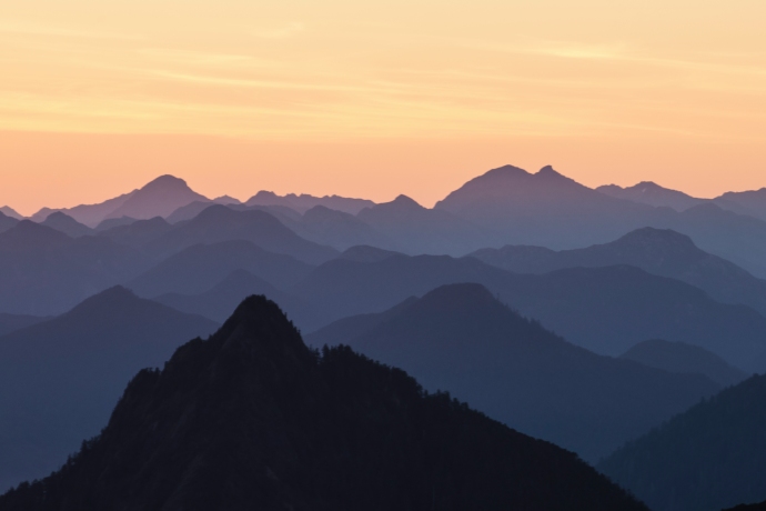 Une vaste chaîne de montagnes au coucher du soleil. 