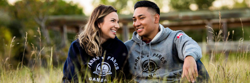 Two people wearing Parks Canada hoodies.