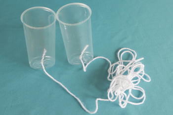 Both cups are connected by a long string
