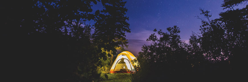 A tent glows amongst the stars at Riding Mountain National Park.