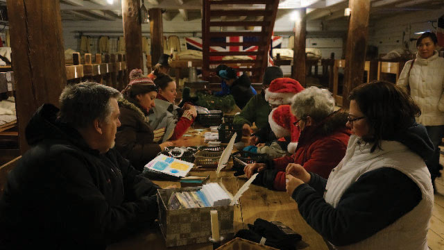 Guests partake in making crafts of the era in the soldiers’ barracks at Fort George.
