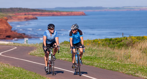 Two visitors biking on the Gulf Shore Way West trail.