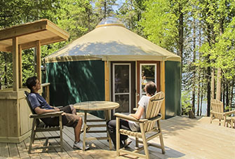 A yurt deck provides plenty of space to relax in deck chairs, cook or keep warm by the fire.