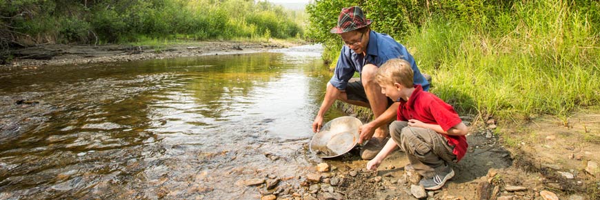 A father and son pan for gold at Bonanza Creek