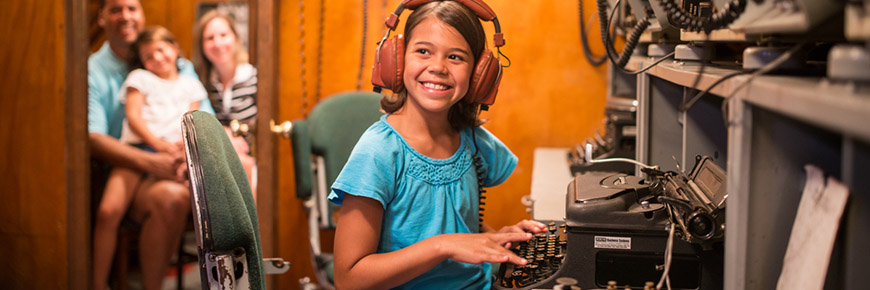 A young visitor and her family on Radio 1 at HMCS Haida National Historic Site
