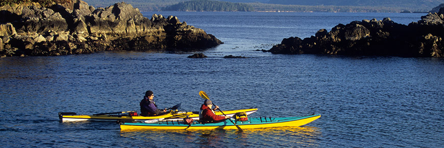 Two kayakers paddle through the Broken Group Islands