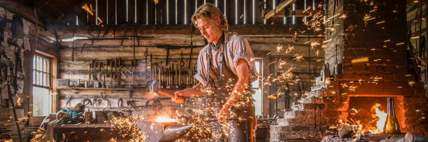 A blacksmith works in his workshop.