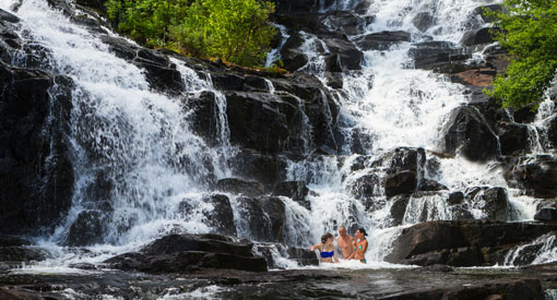 Visitors relax in the Waber Falls in La Mauricie National Park.
