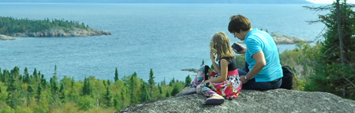 Two people on at a viewpoint overlooking Lake Superior.