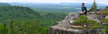 A person at a viewpoint overlooking Lake Superior.