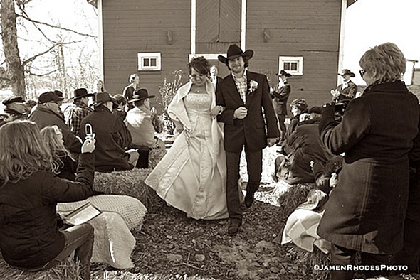 Bride and groom by the dairy barn