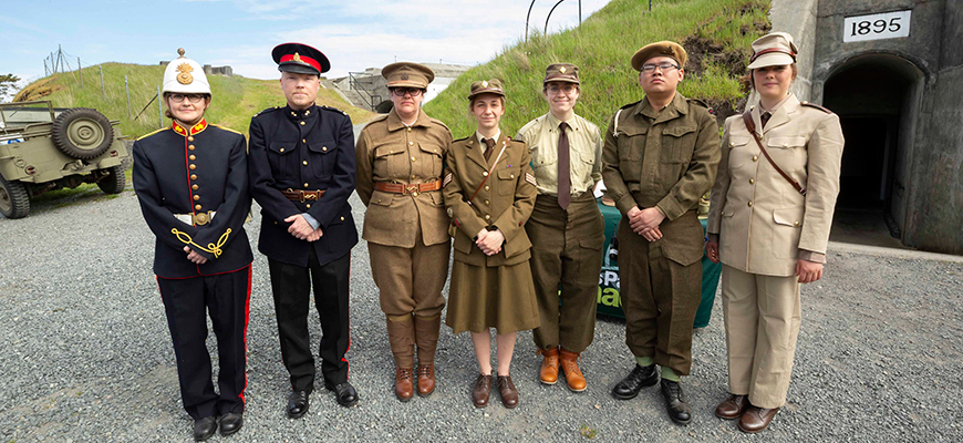 Seven Parks Canada interpreters dressed in various period uniforms
