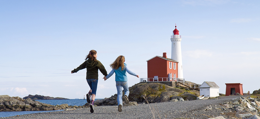 Young visitors run and skip along the causeway on their way to and from the Fisgard Lighthouse