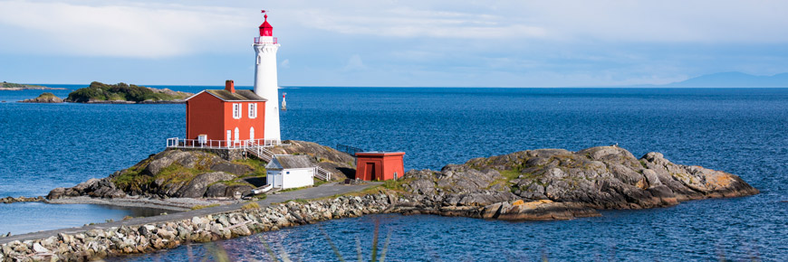 Fisgard Lighthouse National Historic Site and the Juan Du Fuca Strait on a sunny day.