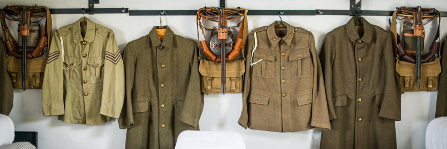 Soldiers’ uniforms hanging in the Casemate’s Barracks exhibit, Lower Battery.
