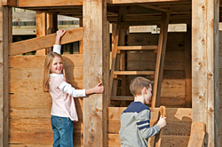Children building the playhouse walls