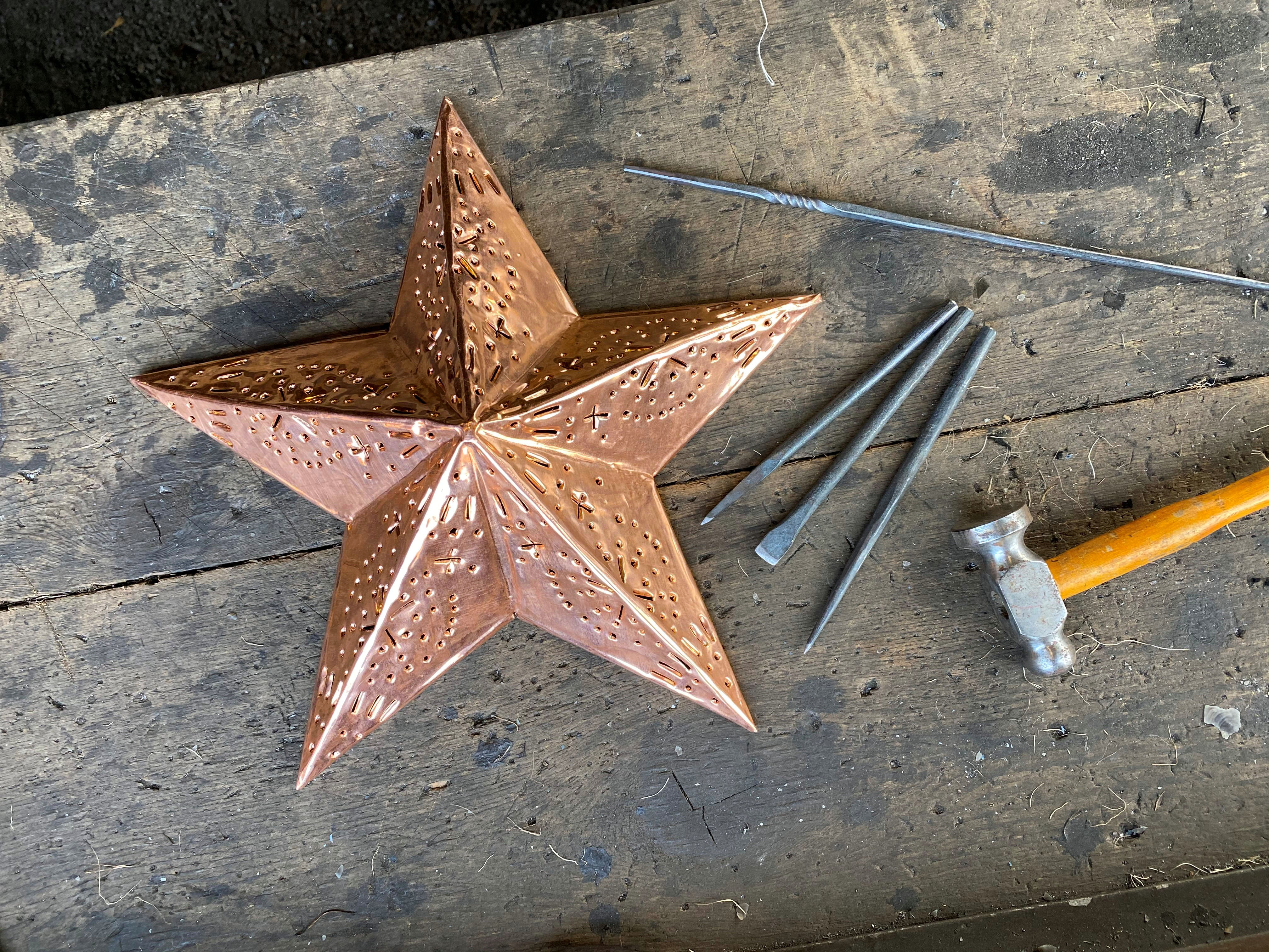 Copper star ornament on table with crafting tools 