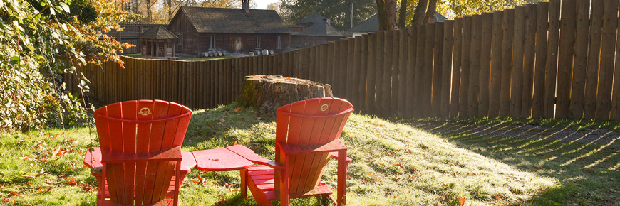 Parks Canada red chairs outside Fort Langley’s palisade