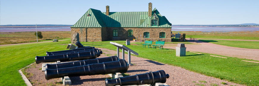 An exterior view of the museum with many cannons 