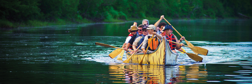 Visitors on a voyageur canoe