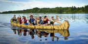 A group of people on a voyageur canoe