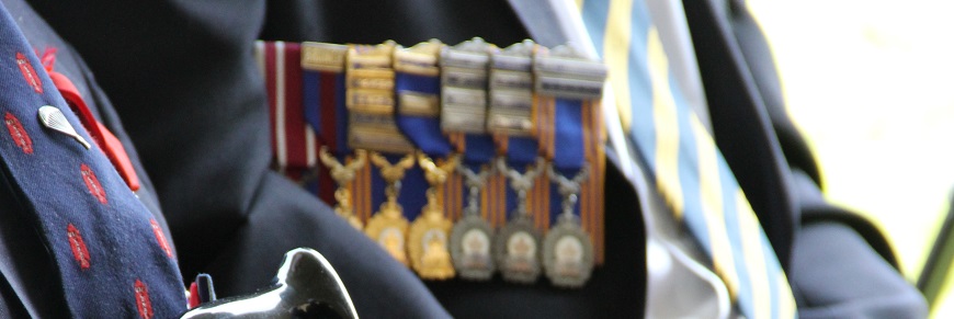Two veterans with military medals. 