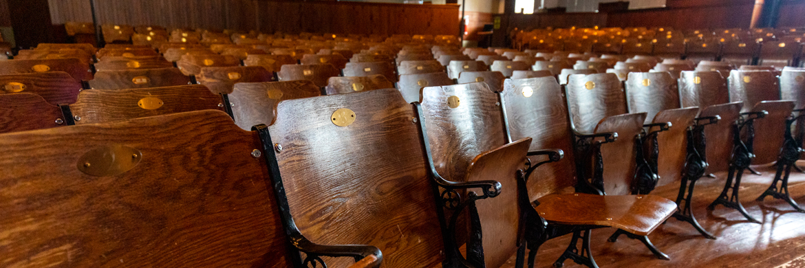 A row of wooden theatre seats