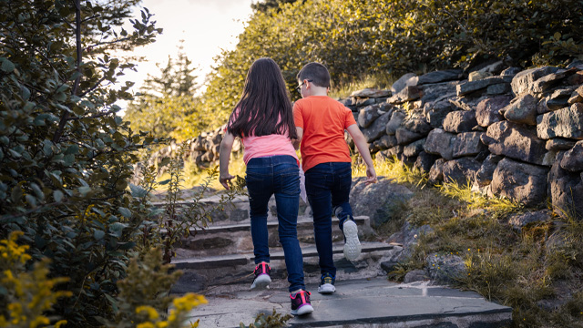 two children running up a set of outdoor stairs.