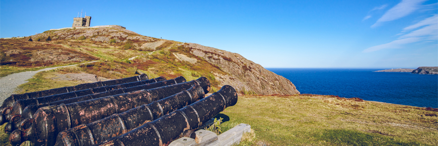cannons overlooking the ocean with Cabot Tower in the background