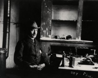 black and white photo of Marconi sitting next to his receiving apparatus