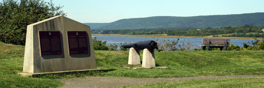 The Charles Fort monument, a cannon, and a bench overlook the Annapolis River. 