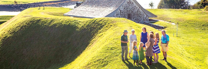 A group of visitors and tour guide on a tour of Fort Anne National Historic Site. 