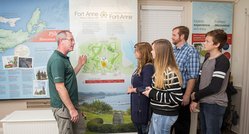  A Parks Canada interpreter explains a map to a group of visitors.