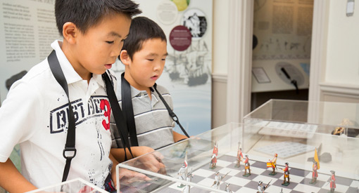  Two young visitors look at a historic display of Fort Anne under plexi-glass.