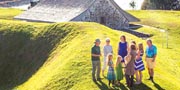 A group of visitors exploring the defensive banks, ditches, and bastions on a guided walking tour of Fort Anne National Historic Site. 