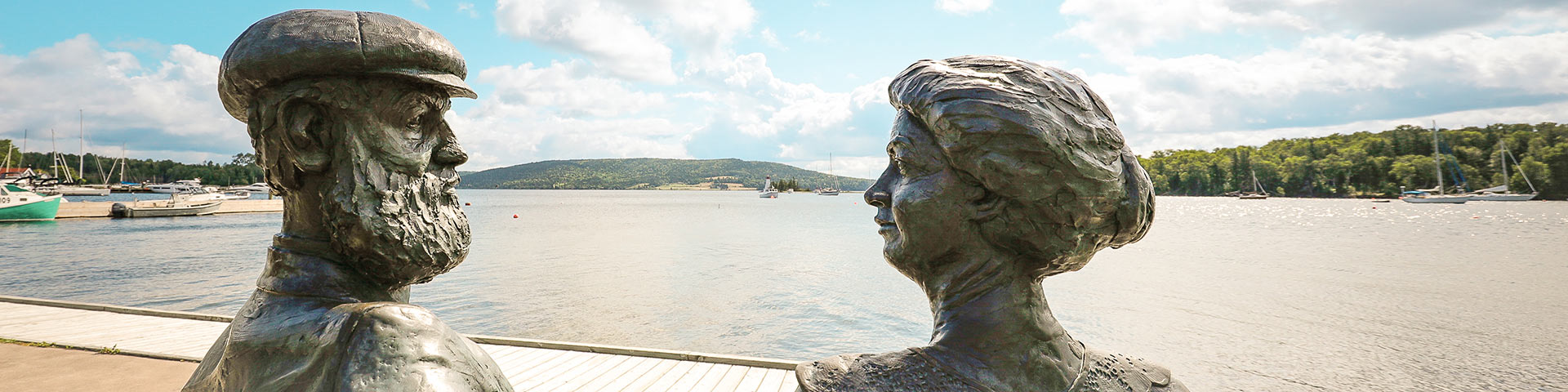 Statues of Alec and Mabel Bell with Baddeck Bay in the background