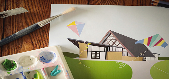 les peintures, des pinceaux et des crayons se trouvent à côté d'un dessin animé d'un bâtiment avec des cerfs-volants au premier plan