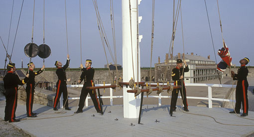 Hoisters raise the appropriate signals on the military signal mast.