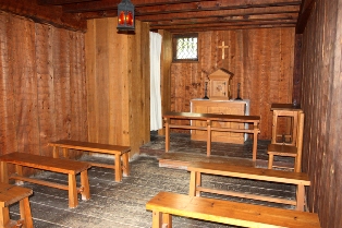 Confessional, altar, tabernacle and crucifix inside the Habitation’s chapel 